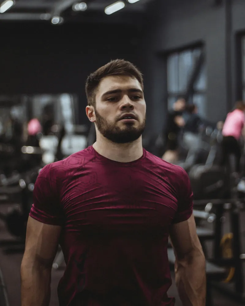 Athletic man with beard training confidently in the gym