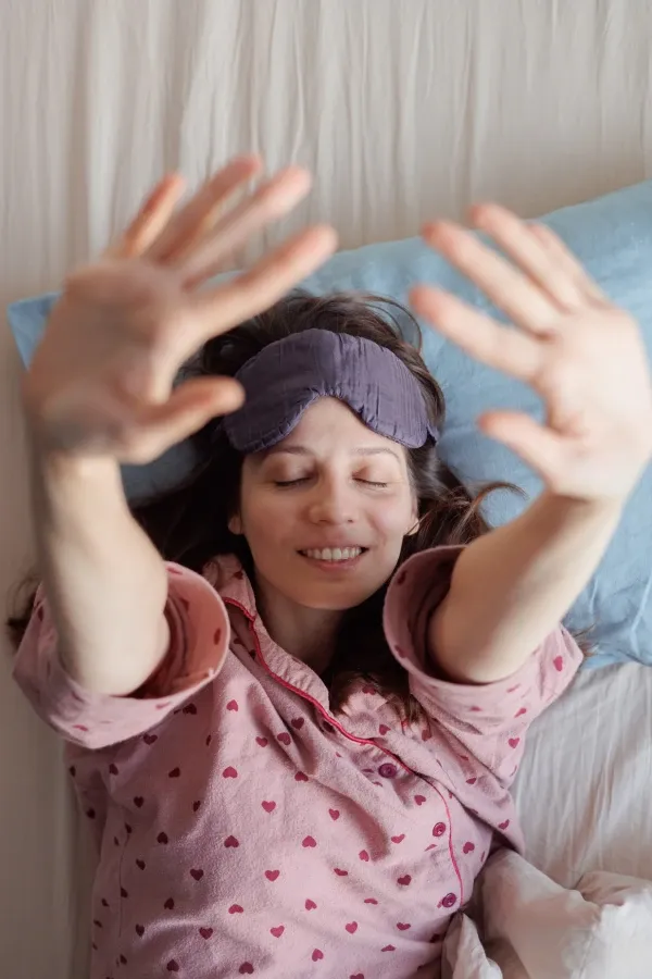Woman resting comfortably in bed at home