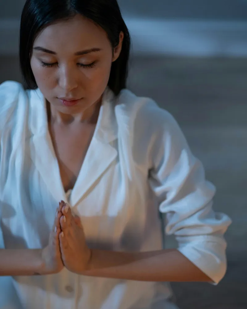 Woman in a peaceful meditative state with eyes closed, embracing calm and mental wellbeing